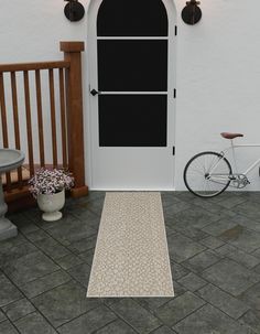 a bicycle is parked in front of a white door