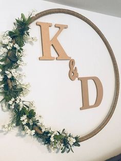 the letter k and d are made out of wooden letters with flowers on each side