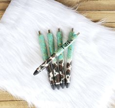 four pens sitting on top of a white fur covered floor