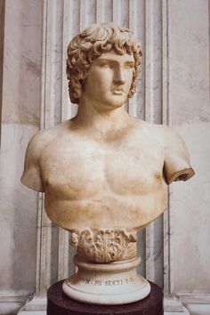 a marble bust of a man in front of a column with columns on either side