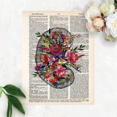 an image of flowers in the shape of a heart on top of a book page