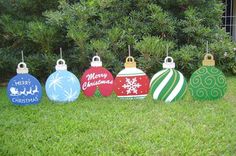 christmas baubles are lined up in the grass