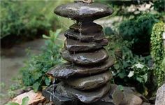 a fountain made out of rocks in a garden