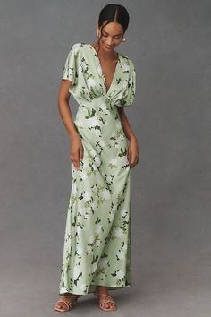 a woman in a green floral print dress