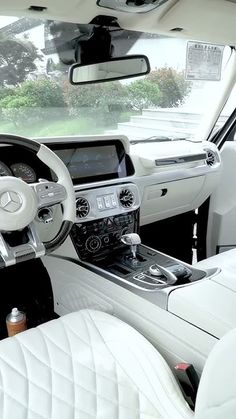 the interior of a car with white leather seats and steering wheel, dash board, dashboard