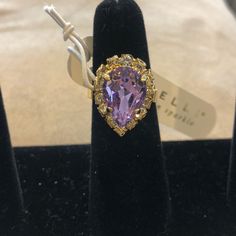 This Wonderful Sorrelli Pear Cut Crystal Ring Features A Lavender Crystal Center Stone That Is Surrounded By Brilliant Clear Crystals. The Setting Is A Wonderfully Contemporary Bright Polished Gold Finish. Adjustable Sizing Roughly 6.5-8 We Ship A Fresh New Ring From Our Warehouse Sorrelli Stamped Sorrelli Pouch And Designer Card 2r Elegant Teardrop Purple Amethyst Ring, Elegant Purple Teardrop Amethyst Ring, Elegant Teardrop Amethyst Ring For Formal Occasions, Elegant Adjustable Gold Amethyst Ring, Elegant Adjustable Amethyst Gold Ring, Elegant Pear-shaped Amethyst Ring, Formal Lavender Amethyst Ring, Elegant Adjustable Amethyst Ring, Elegant Teardrop Rings For Party