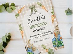 a birthday card with an image of a rabbit and carrots on it, surrounded by greenery