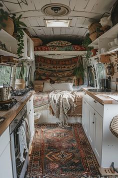 the interior of an rv with rugs on the floor and cabinets in the back