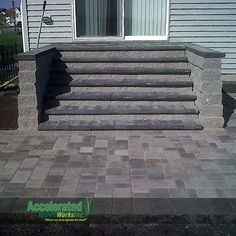 an outdoor patio with steps leading up to the front door