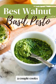 a bowl of pesto next to bread on a cutting board with the title best walnut basil pesto