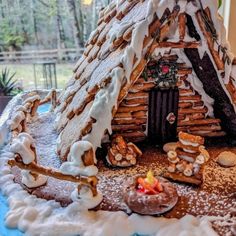 a gingerbread house made to look like it is in the snow