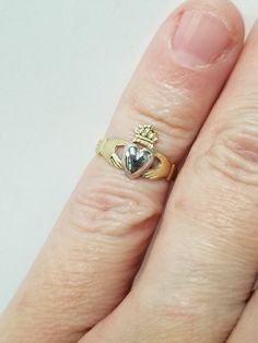 "Thanks for shopping our vintage estate store. We tend to sell well below wholesale and truly hope you enjoy all of our items. Many of the items are one of a kind, so please enjoy scrolling through the pictures and hopefully something will catch your eye. Blacks spots are from camera or reflections. Beautiful estate 14k gold yellow white gold Irish Claddagh infant or baby ring. Retails $299 on sale $149 Ring size: 1 Setting: 3/8\" 8.5mm Band width: 2mm Weight: .1.07 grams Beautiful ring, one tha Classic Heart Jewelry For Collectibles, Classic Heart-shaped Collectible Jewelry, Classic Heart Shaped Collectible Jewelry, Vintage 14k Stamped Heart Cut Jewelry, Collectible 14k Gold Heart-shaped Jewelry, Heirloom Heart Ring Stamped 14k For Anniversary, Collectible Yellow Gold Birthstone Rings, Yellow Gold Rings With Birthstone, Vintage Yellow Gold Heart Ring As A Gift