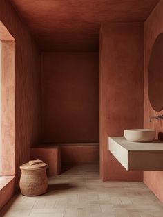 a bathroom with pink walls and tile flooring