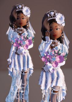 two black dolls dressed in white and pink outfits with flowers on their heads, one holding her hand to her face