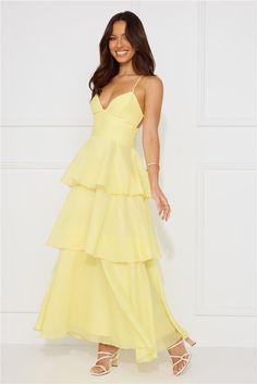 Length from bust to hem of size S: 118cm. Chest: 36cm, Waist: 31cm, across front only of size S. Maxi dress. Lined. Model is a standard XS and is wearing size XS. True to size. Non-stretch. Tiered flowy skirt. Crisscross tie-up back. Elastic back. Zipper. Cold hand wash only. Polyester. Enter the event and impress! The Mysterious Beauty Maxi Dress features an extravagant tiered flowy skirt and a crisscross back tie design. Style with heels and curls for all the attention. Sorority Formal Dress, Asymmetrical Tiered Skirt, Mysterious Beauty, Frill Skirt, Yellow Bridesmaids, Dress Yellow, Tiered Maxi Dress, Ruffled Maxi Dress, Flowy Skirt