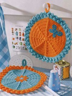 there is a crocheted orange and blue object on the table next to it