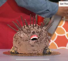 a cake shaped like a hedgehog with spikes on it's head and eyes