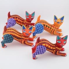 five colorful cat figurines sitting next to each other