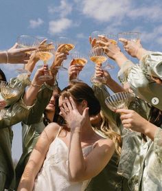 a group of people holding wine glasses in the air