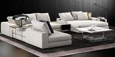 a modern living room with black walls and white couches, coffee table and lamp