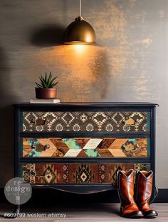 a pair of brown boots sitting on top of a dresser next to a potted plant