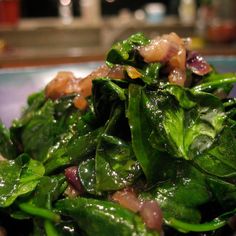 spinach salad with bacon and onions on a plate