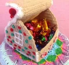 a crocheted gingerbread house with candy in it