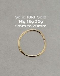 an image of a gold ring with measurements for the size and width, on a grey background