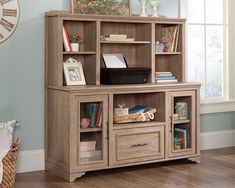 a bookcase with drawers and shelves in a room