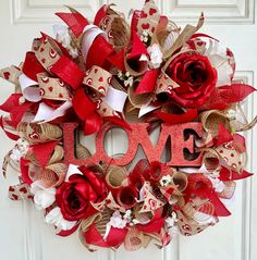 a valentine's day wreath with the word love spelled out