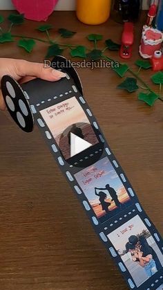 someone is holding a roll of film with pictures on it