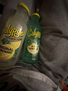 two bottles of calories are sitting on a bed