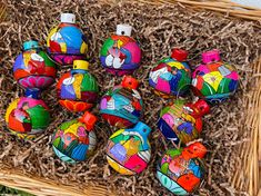 a basket filled with lots of colorful painted ornaments