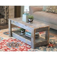 a living room area with a couch, coffee table and rug on the carpeted floor