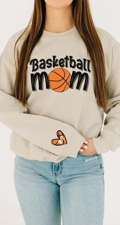 The Personalized Basketball Mom Shirt is perfect for the Basketball Mom Era, showcasing pride with a custom design. This Basketball Mom sweatshirt makes a thoughtful gift for proud basketball moms. 𝐃𝐄𝐓𝐀𝐈𝐋𝐒 🔷This Design comes with Basketball Mom on the front and a Basketball Heart with Name on the Right Sleeve 1/2 inch above the Cuff  🔷If you would not like the sleeve print, put no Sleeve Print in the Personalization Box 🔷 Super Soft and High Quality Shirts 🔷 Fashionable for women 🔷 S Custom Print Cotton Sweatshirt For Sports Events, Customizable Cotton Tops For Sports Season, Customizable Cotton Sweatshirt, Varsity Crew Neck Top With Custom Print, Cotton Sweatshirt With Custom Print For Game Day, Cotton Long Sleeve Sublimation T-shirt For Sports Events, Basketball Mom Shirt Ideas, Mom Basketball Shirt Ideas, Basketball Parent Shirts