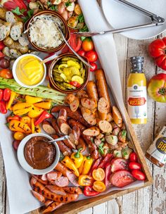 an assortment of vegetables and meats on a cutting board