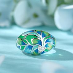 How beautiful is this sweet spring ring? The ring features flowers and leaves that wrap around your finger, detailed with bright enamel for lovers of colour! The perfect accessory for spring and summertime, or to keep the floral vibe going all year round.Carat Weight: 0.072 ctStone Size: 1.4 mmNumber of Stones: 3 Stone Shape: RoundStone Color: Diamond WhiteWeight: 4.79 gWidth: 3.7 mmHeight: 7.7 mmThickness: 1.6 mmMaterial: 925 SilverPlating Color: Silver Spring Hand Painted Jewelry, Green Enamel Ring For Wedding, Hand Painted Jewelry For Spring, Hand Painted Jewelry As Spring Gift, Hand Painted Jewelry For Spring Gift, Green Enamel Wedding Ring, Green Flower-shaped Enamel Jewelry, Green Rings As Summer Gift, Green Rings Suitable For Summer Gifts