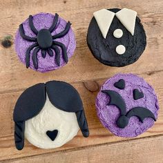 three cupcakes decorated with black and purple icing, one has a spider on it