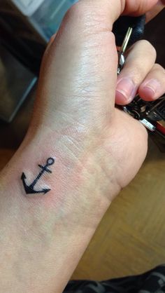 an anchor tattoo on the wrist is shown in this image, it looks like someone has been inked