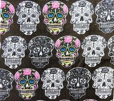 a bunch of skulls with flowers on them are all in different colors and sizes, as well as black background