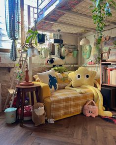 a living room filled with lots of furniture and bookshelves covered in stuffed animals