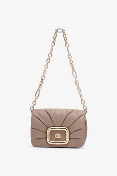 Beige leather crossbody bag from Roger Vivier. The Vic Choc crossbody bag is made of leather with an elegant drape and iconic branded metal rounded buckle. It is closed with flap and magnetic button, and comes with a removable shoulder strap and zipped pocket on the back. Measurements: L24 x H12.5 x W6 cmMade in Italy Beige Clutch Shoulder Bag With Magnetic Closure, Beige Crossbody Bag With Magnetic Closure, Beige Shoulder Bag With Magnetic Closure For Evening, Beige Crossbody Bag With Turn-lock Closure, Beige Flap Bag With Magnetic Closure For Evening, Beige Evening Flap Bag With Magnetic Closure, Beige Flap Bag For Evening, Beige Evening Bag With Flap, Taupe Crossbody Bag For Evening