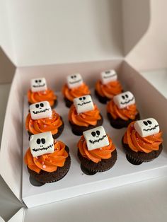 a box filled with cupcakes decorated to look like skeletons