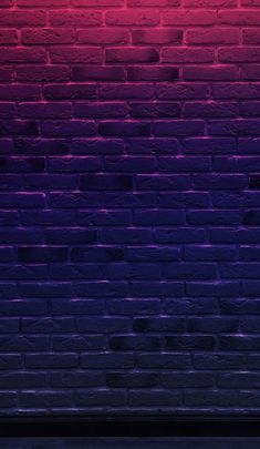 a red and purple brick wall next to a bench