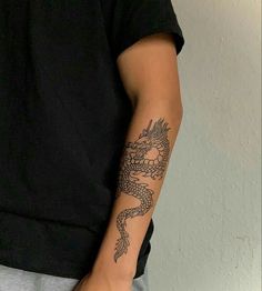 a man with a dragon tattoo on his arm