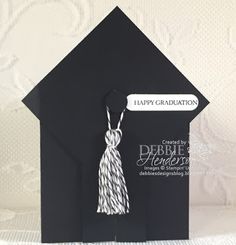 a black graduation card with a tassel hanging from it's front pocket and the words, happy graduation