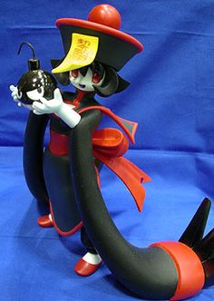 a toy figurine is posed on a blue background wearing a red hat and black gloves