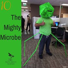 a man in an office with a green bag on his head, and the words 10 the mighty microbe