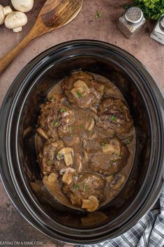 meatballs and mushrooms are cooked in the slow cooker