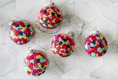 four colorful ornaments on a marble surface